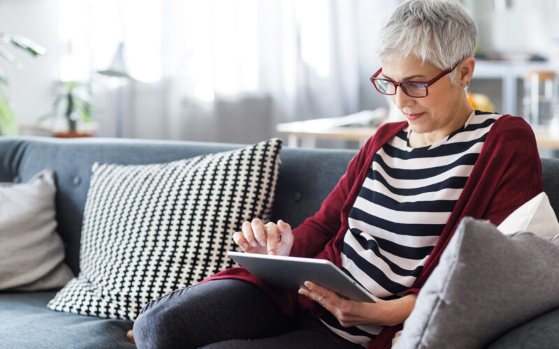 Woman on sofa with ipad
